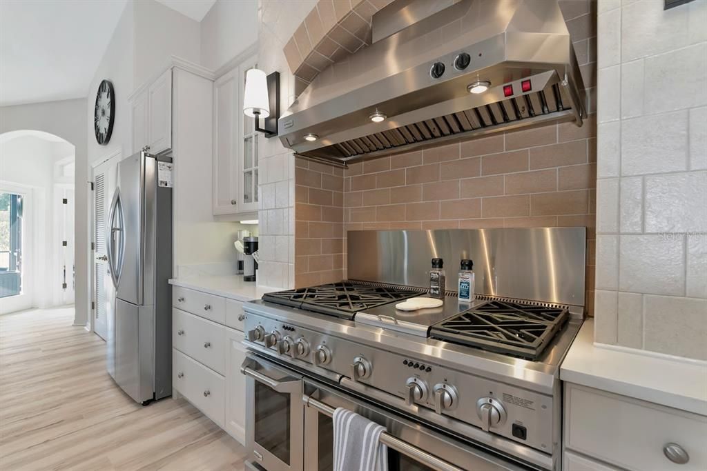 Extended gas stove with double ovens.