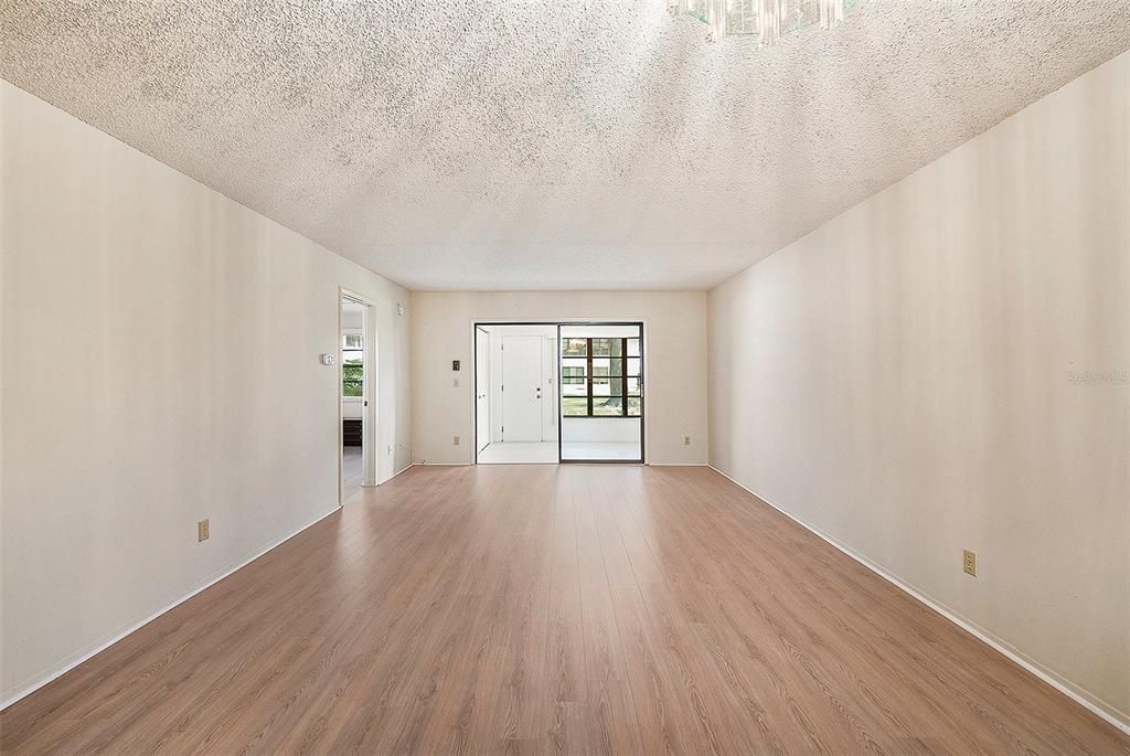 View of the Dining and Living Room Combination with New Laminate Flooring