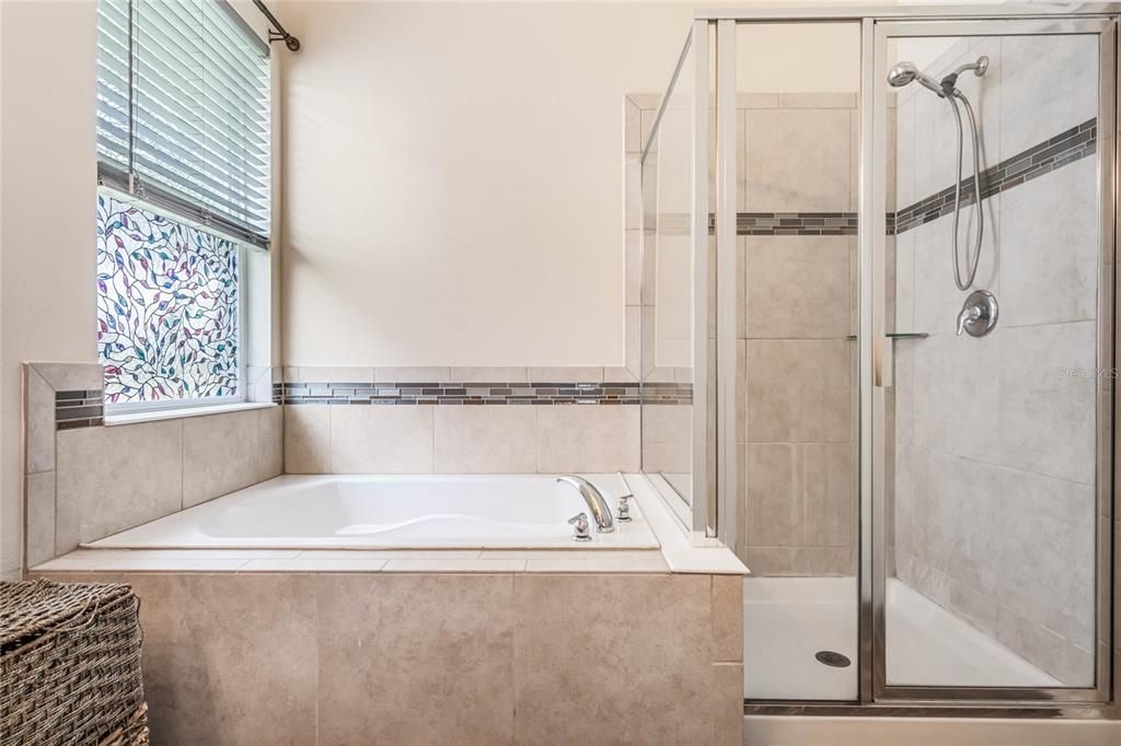 a tub and separate glass enclosed shower