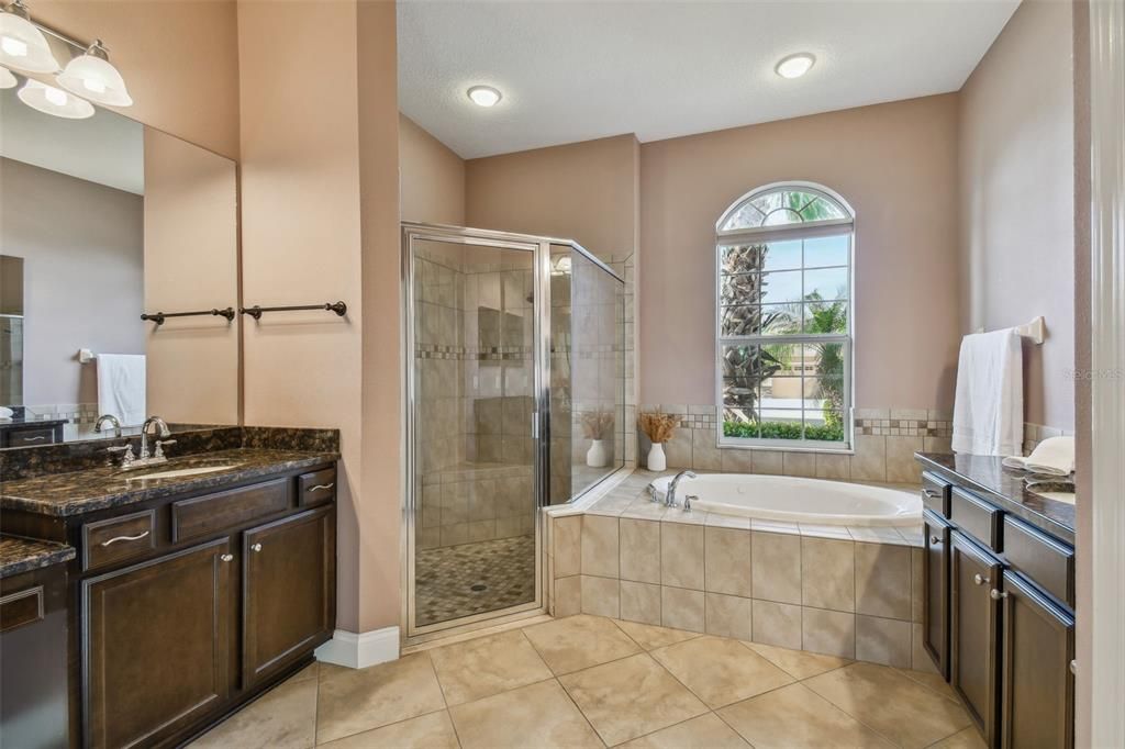 Spacious master bathroom with his/hers