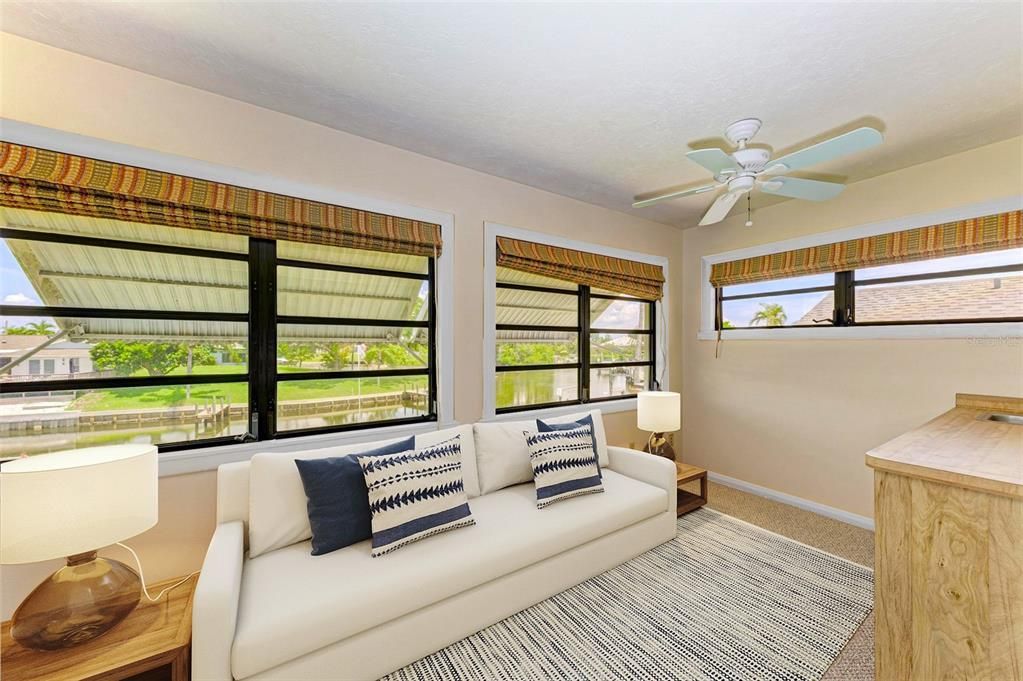 VIRTUAL STAGING - Enclosed Sunroom over the waterfront view with Wet Bar