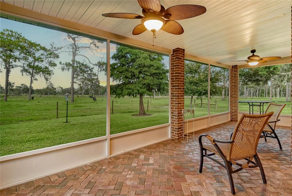 Covered screened-in lanai with views of the property.