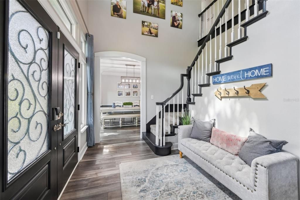 Entrance with dining area to the left and staircase leading to secondary bedrooms and 2 bathrooms