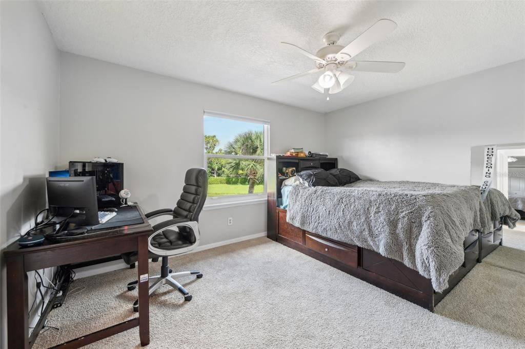 Bedroom 3 upstairs with backyard pond view