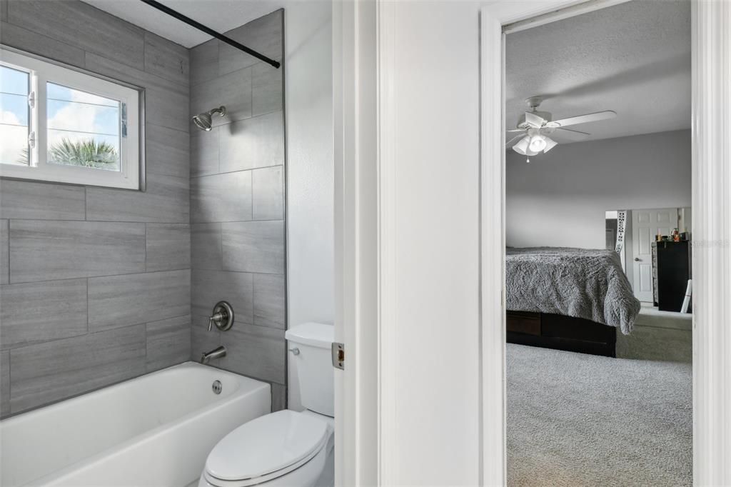 Jack-n-Jill bathroom with tub/shower and modern tile