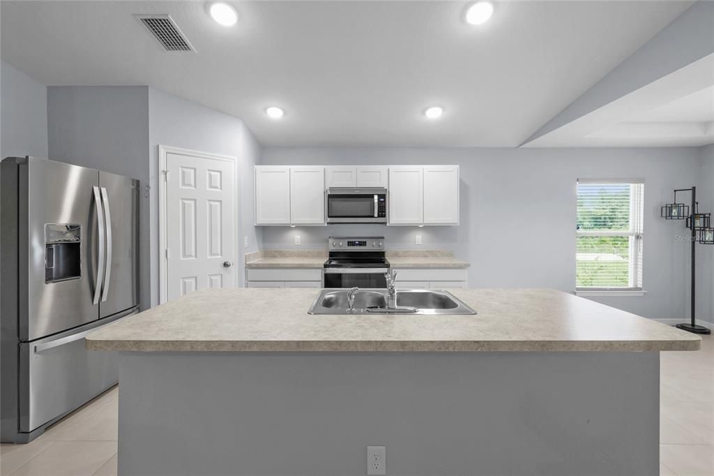 Spacious Kitchen with Island & Sink + quality Whirlpool Stainless Steel Appliance Package