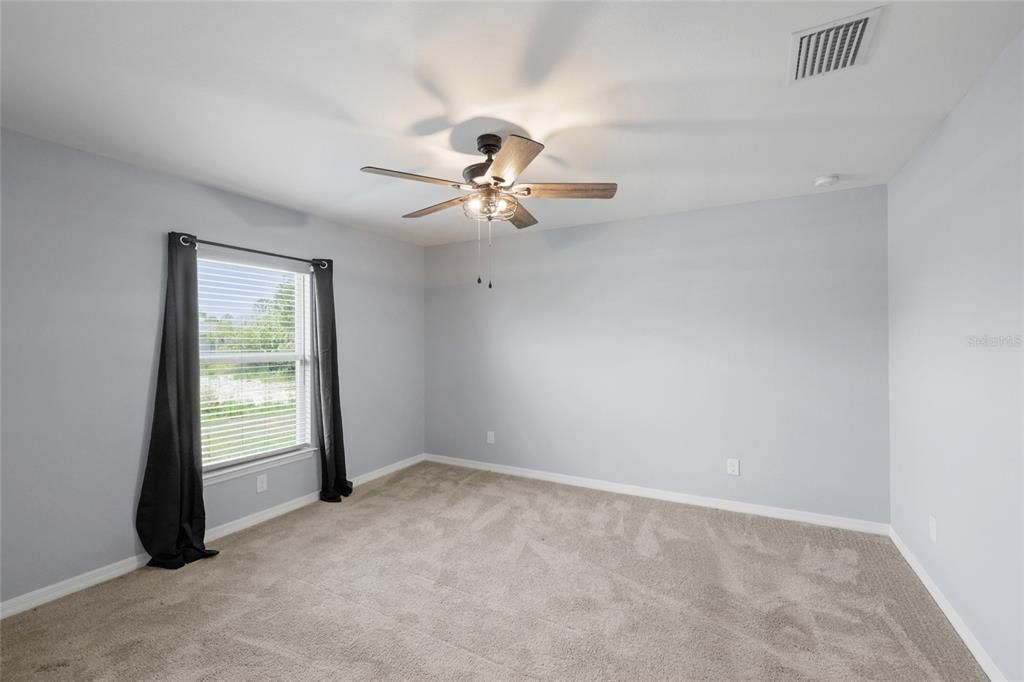 Spacious Primary Bedroom easily accommodates King Size Furniture