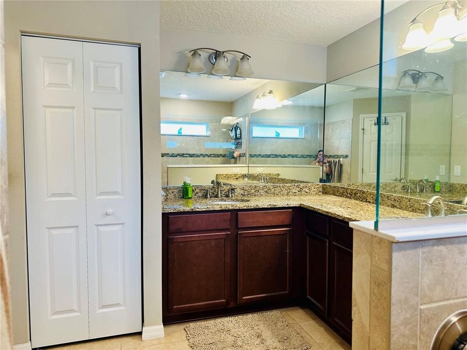 Master bath with his/her sinks, linen closet and separate toilet.