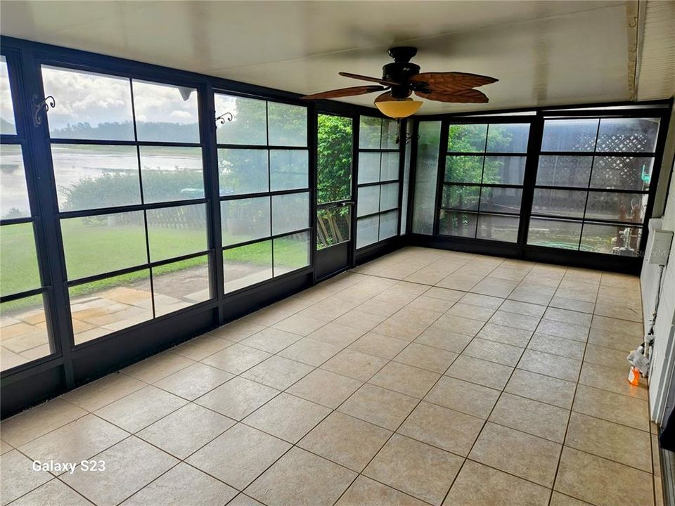 Oversized, enclosed patio overlooks creek and lake