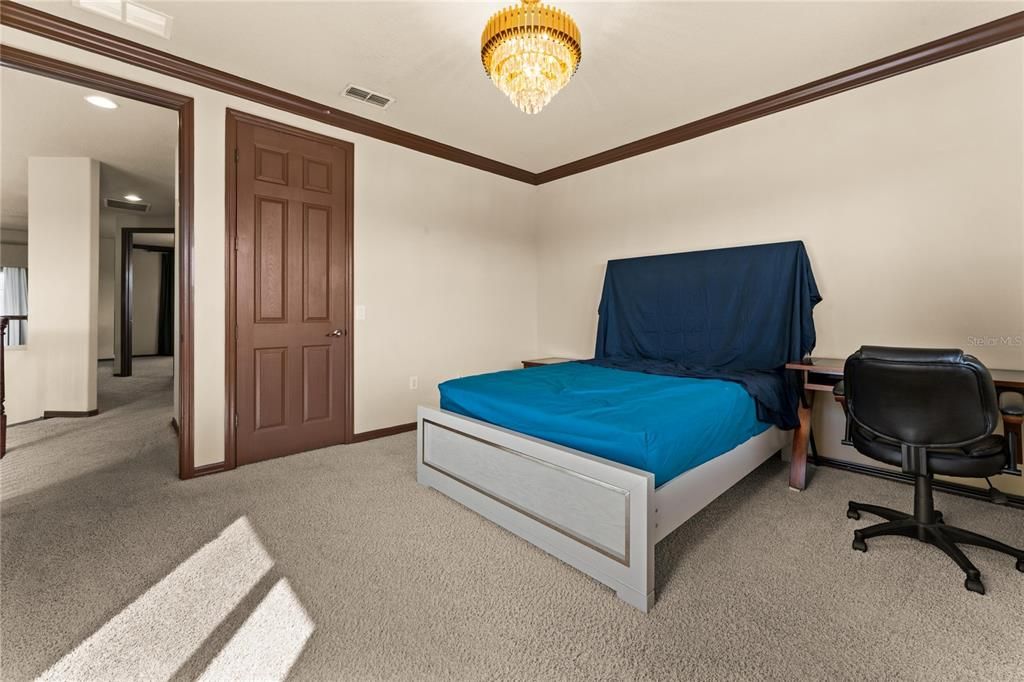 Upstairs bedroom #3 of 6 on the property. Sliding door access to second floor balcony. Water views and walk-in closet next to full bathroom.