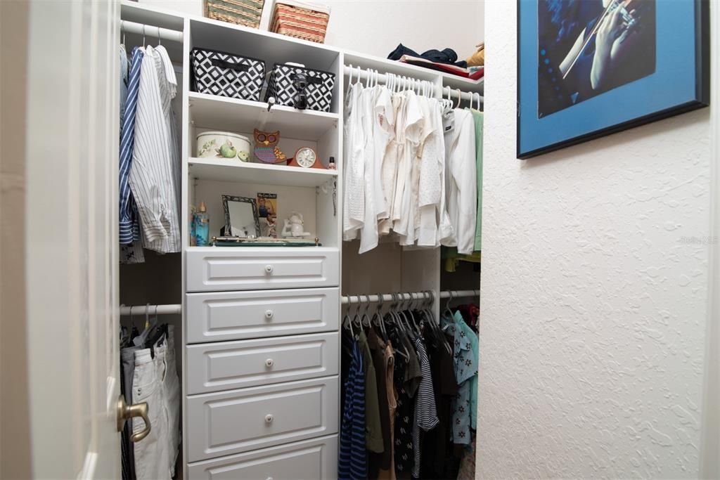 The walk-in closet has built-in cabinetry.