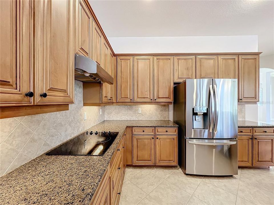 Glass cooktop & professional hood vents out of the house.