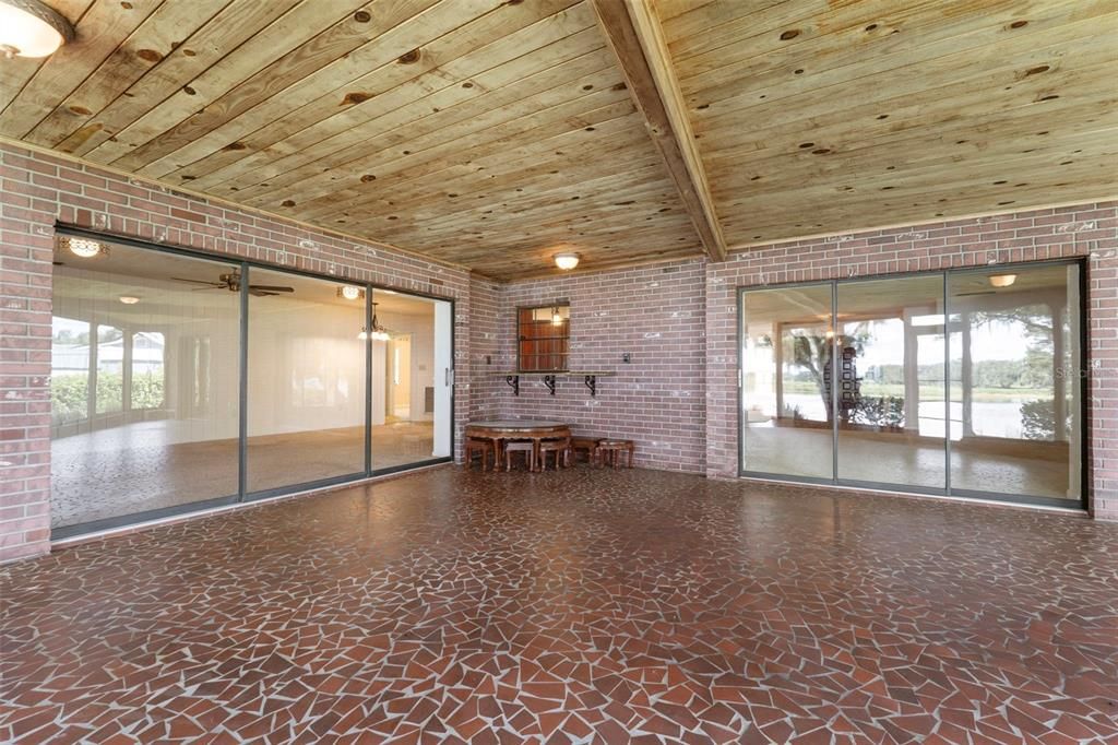 TRIPLE DOORS OPENING TO PORCH FROM LIVING & FAMILY RMS