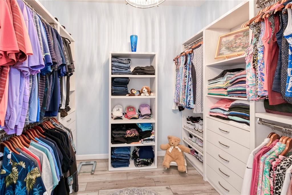 Primary huge walk-in closet with custom shelving