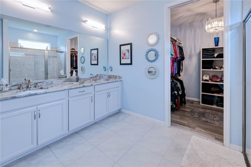 Primary ensuite double sink vanity to huge walk-in closet