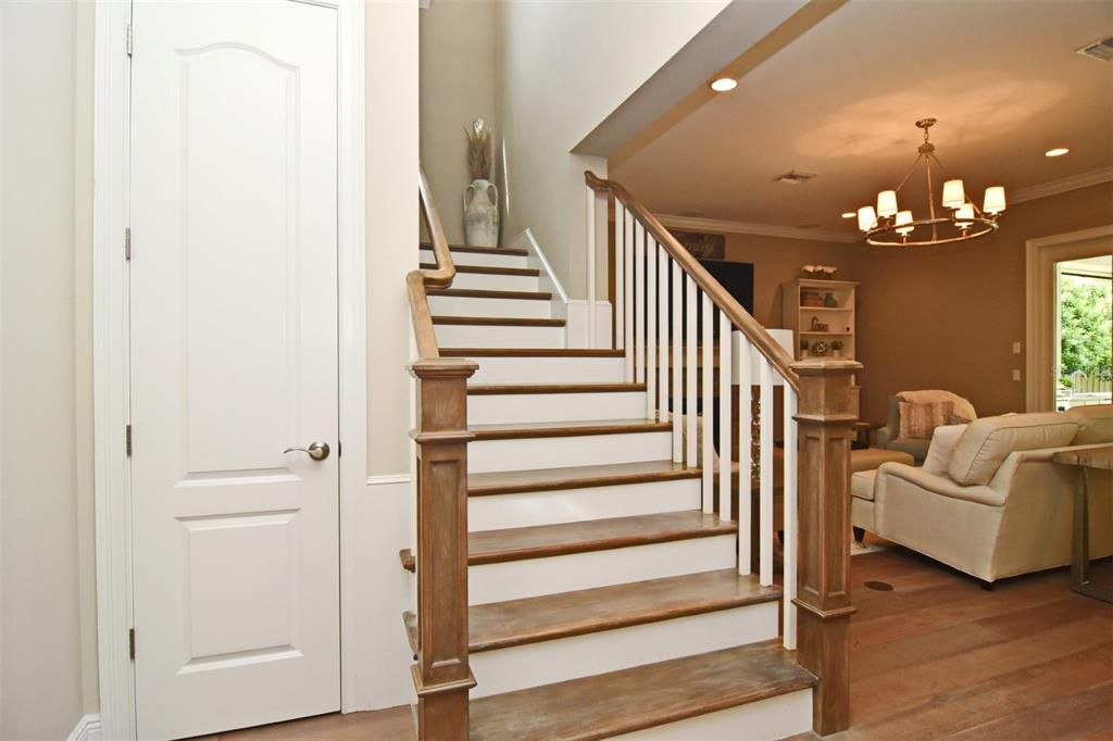 Wood staircase with decorative wood railing, leading to 2nd floor