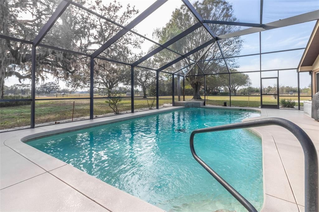 Beautiful swimming pool with screened lanai.