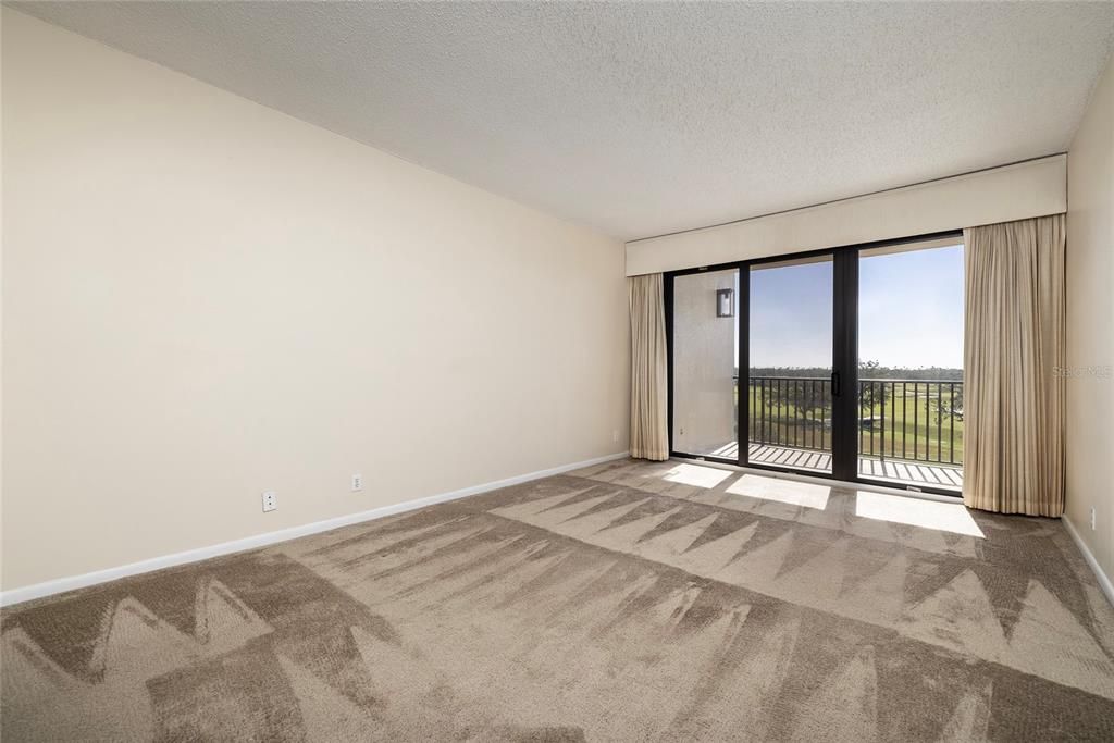 Master Bedroom with Balcony Access -- Golf Course and Water Views