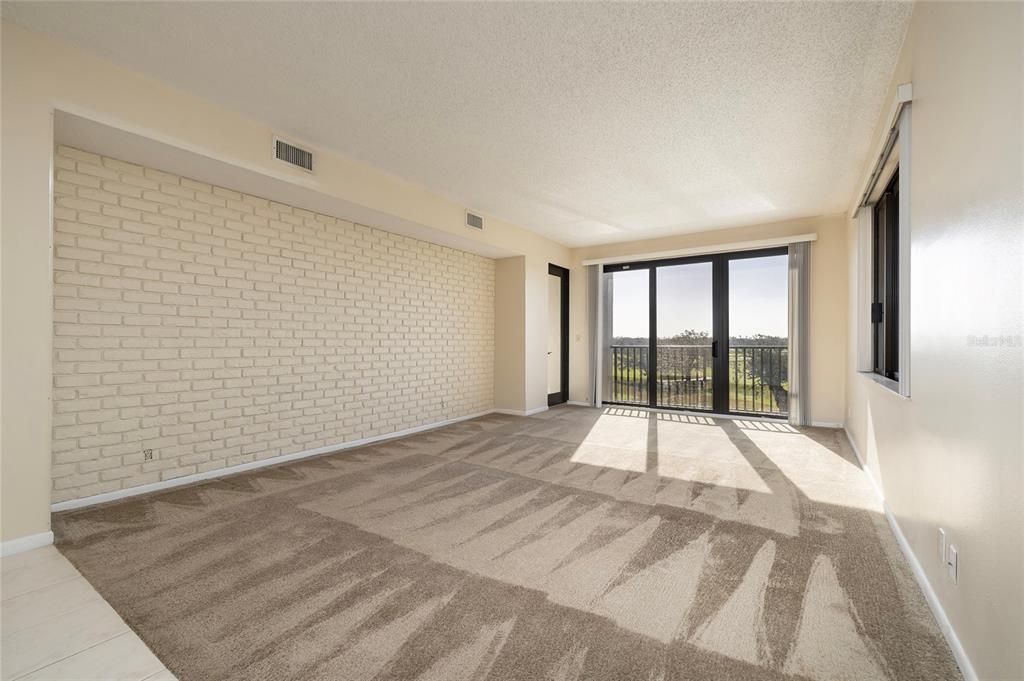 Living Room with Access to both balconies -- Golf Course and Water Views