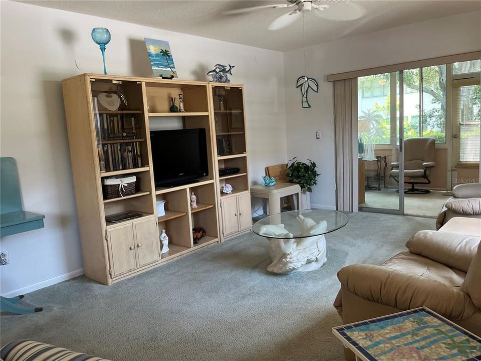 Fully Furnished Living Room looking to Bonus Room Through Sliding Doors