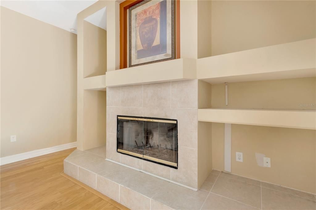 Wood burning fireplace surrounded by built ins