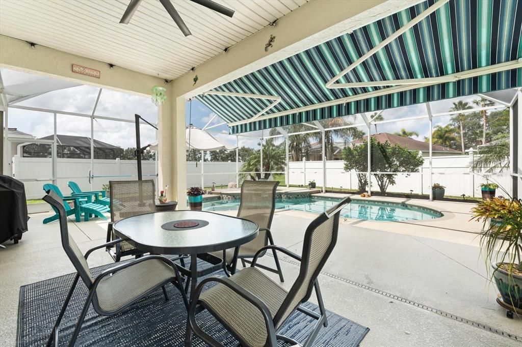 Caged lanai with remote control shade awning.