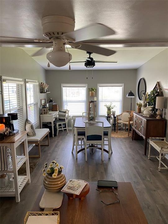 View from kitchen island to dining area with large windows and northern exposure to front of the home