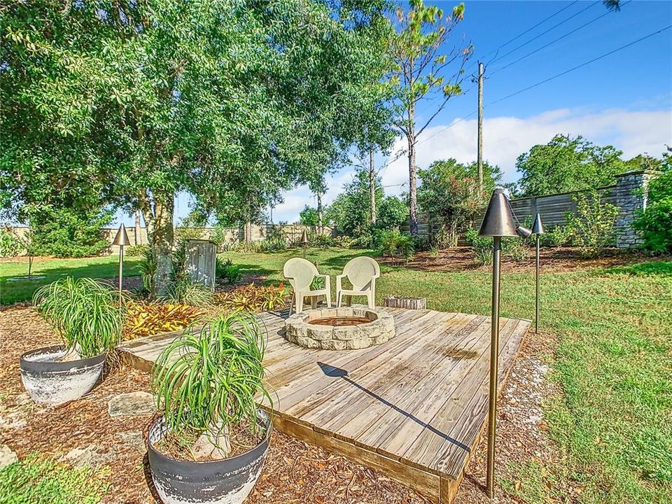 Large wooden platform with stone firepit