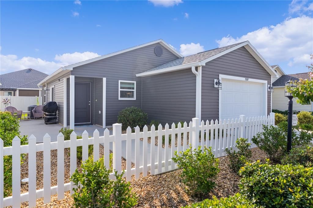 Cottage Patio Villa with a traditional white picket fence