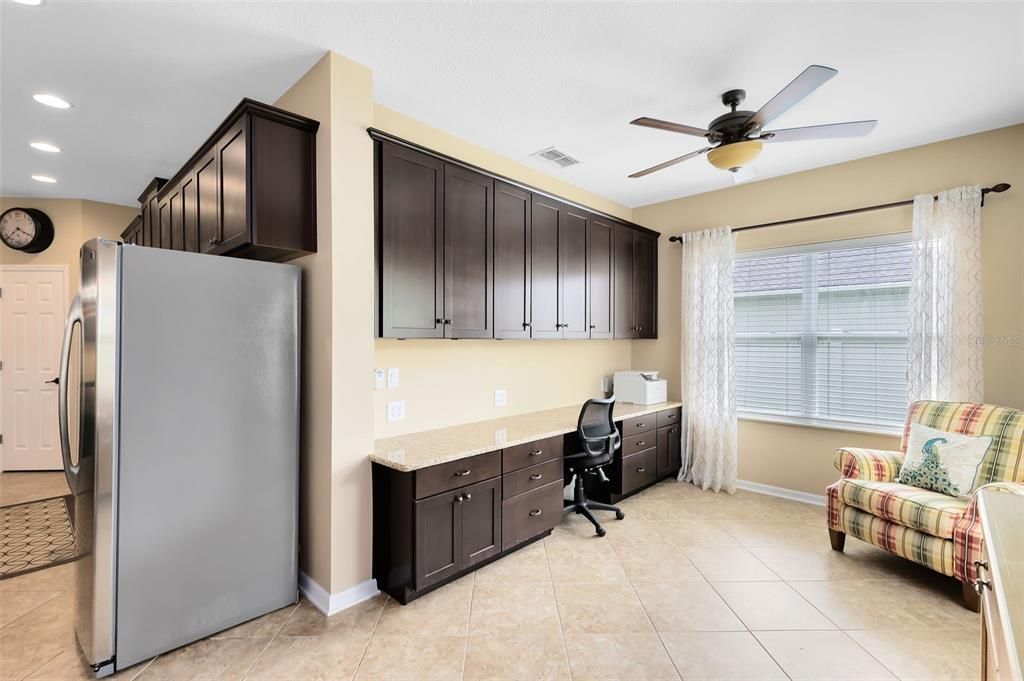 A dedicated office space with built-in desk and storage next to the dinette adds to the home's functionality.