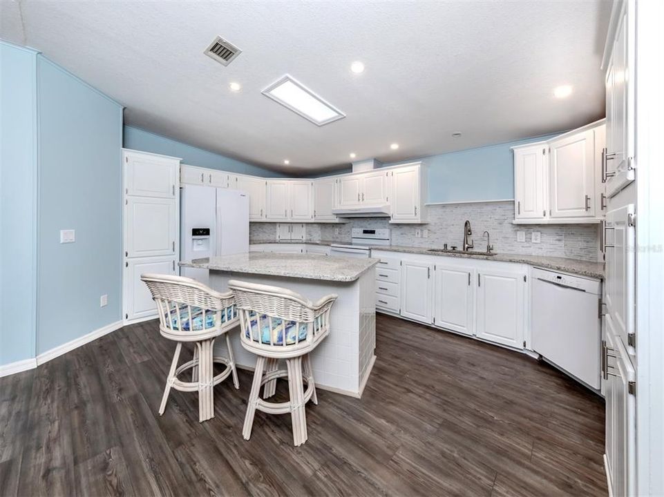 Kitchen with granite counters and new backsplash.