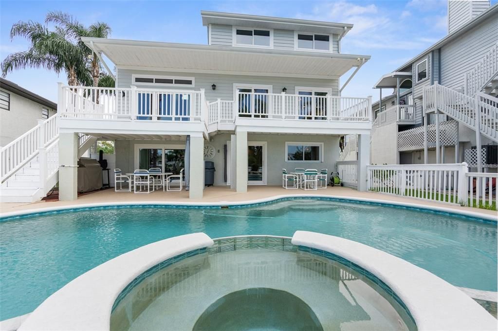 custom pool with overflow spa and water features