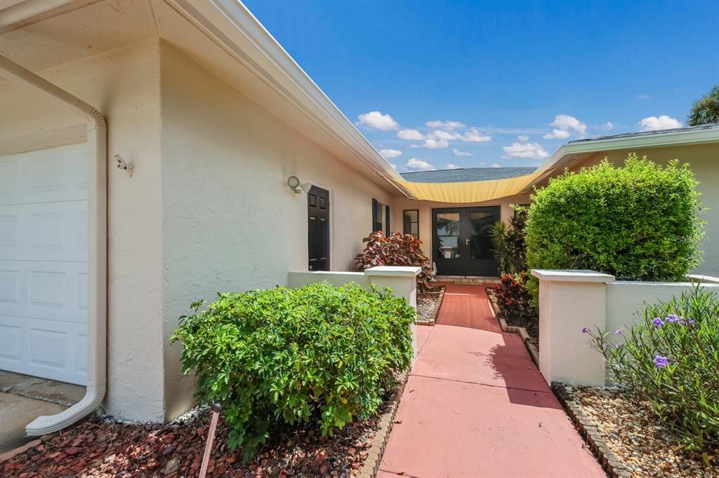 Walkway to the front door and one car garage with side garage door access