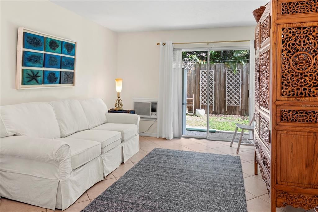 living room with glass sliding doors to covered patio