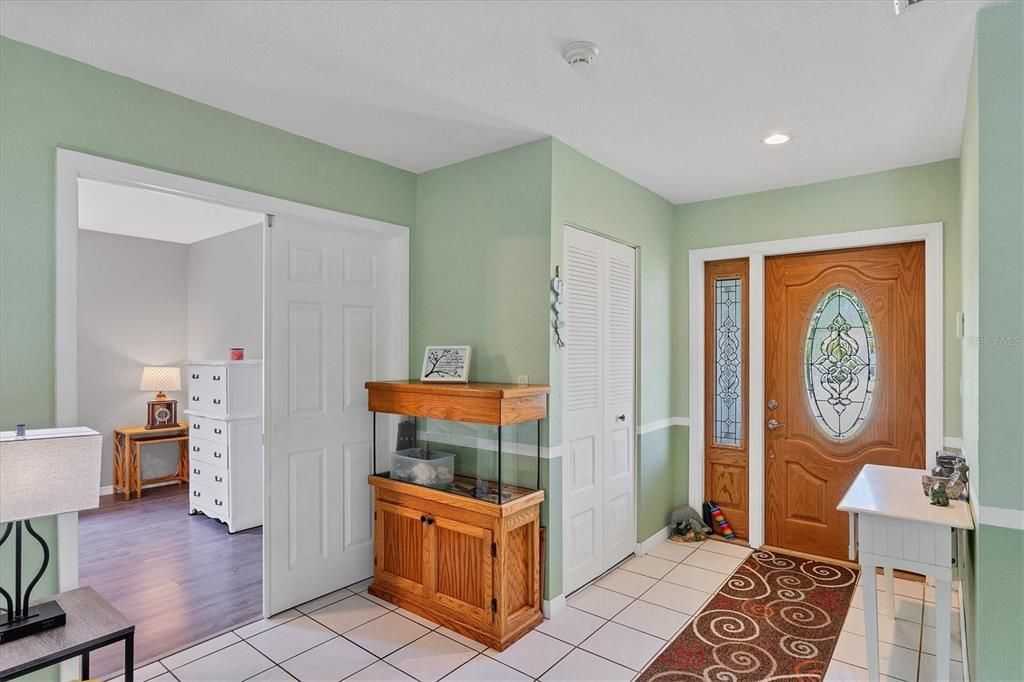 Leaded, etched glass entry door and sidelite; coat closet