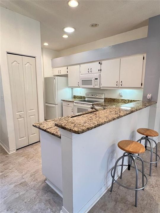 The kitchen has a breakfast bar that overlooks the great room!