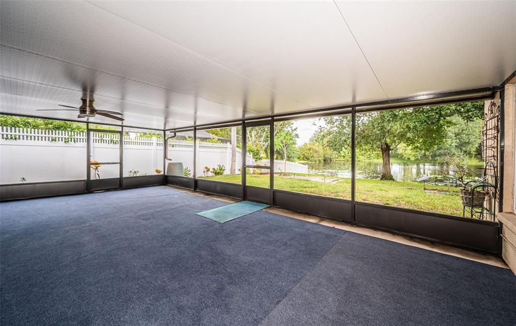 Large screened room with a roof for entertaining on rainy days.