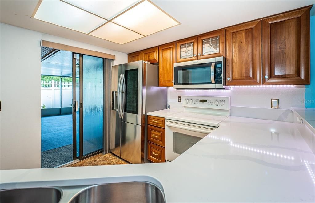 Quartz counters and access to the screened room.