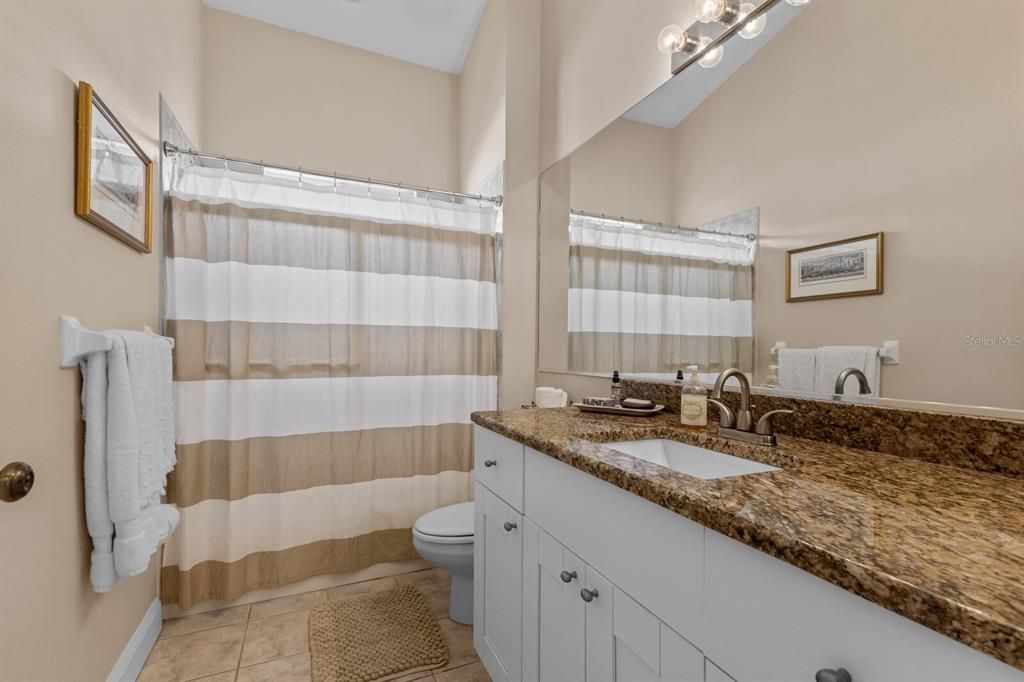 Guest bathroom with updated vanity and granite countertop