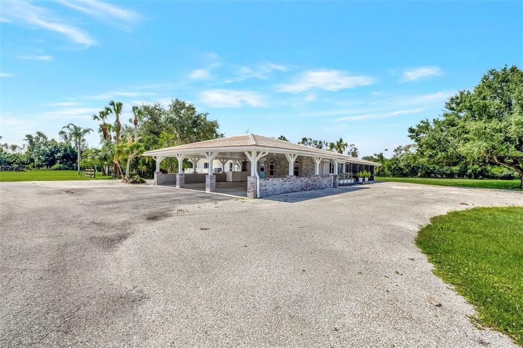 The big carport can accommodate 4 cars.