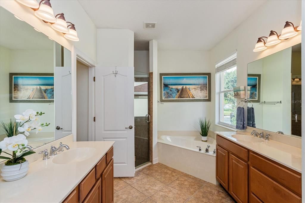 Primary en-suite bath with soaking tub, separate shower and private water closet