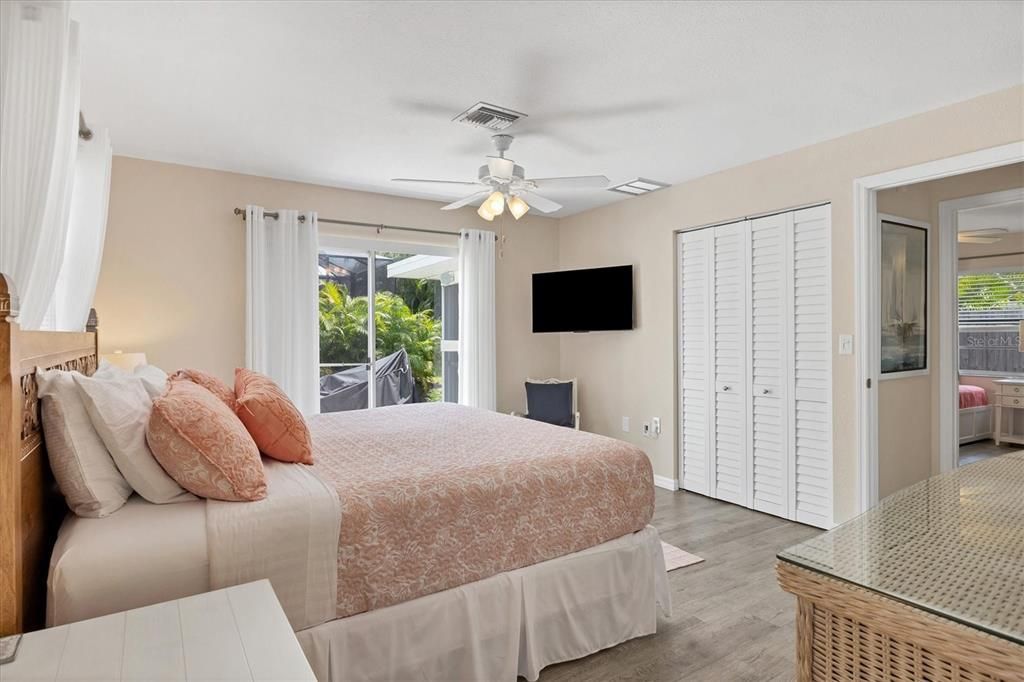 Master bedroom suite with sliders to the outdoor shower & patio.