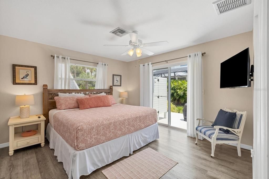 Master bedroom suite with sliders to the outdoor shower & patio.