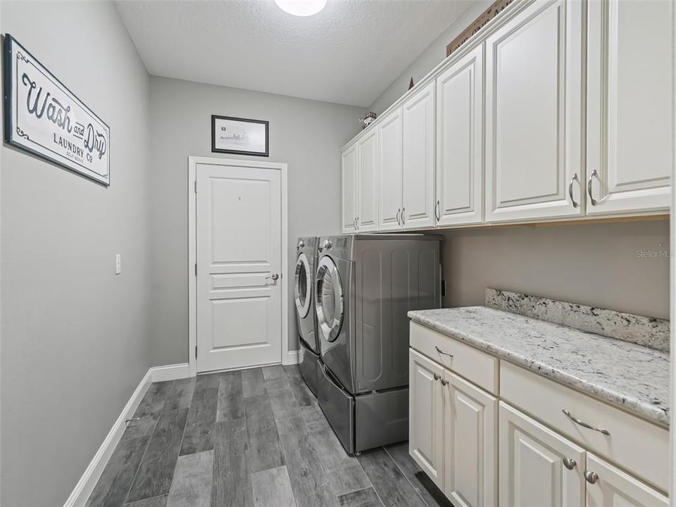 Laundry room with additonal cabinets. raised front loader units