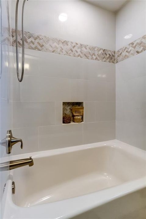 And a FULLY UPDATED Tub w/ Shower.. custom niche, listella, welcoming warm colors draw you in.. Time for a BubbleBath?