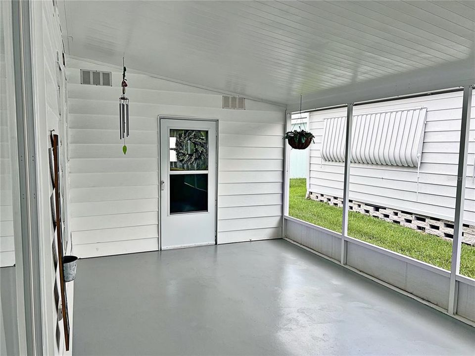 Screened in covered carport with laundry room and outside sink