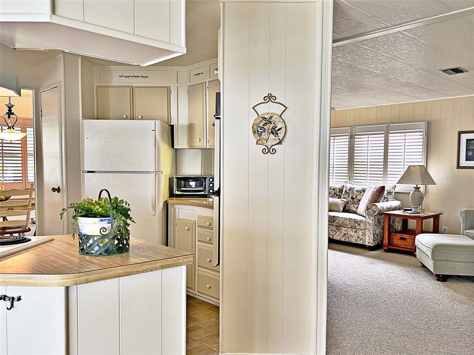 Entry from the screened in carport w view of Kitchen, dinette ns Living room