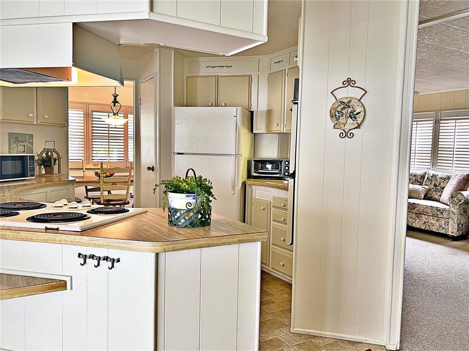 View from sliding glass doors of carport of Kitchen, dinette and Living room