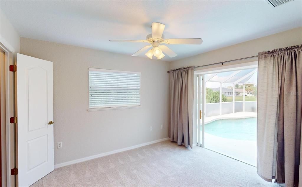 Bedroom #2 with Sliding Glass door to Pool.