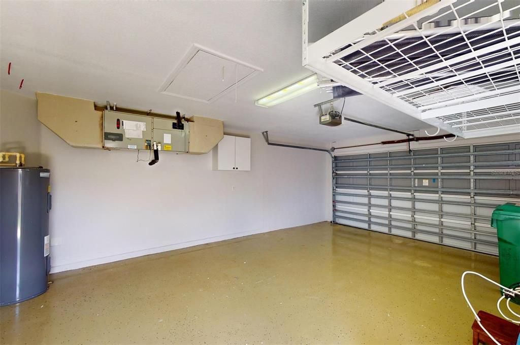 2-car garage with epoxy flooring & storage rack.